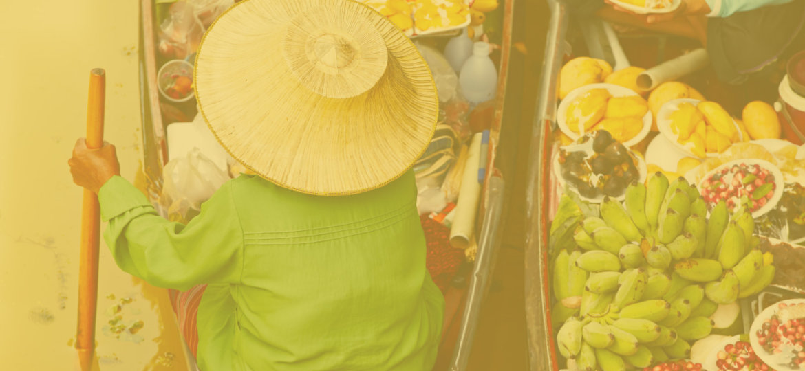 Woman in boat with fresh fruit